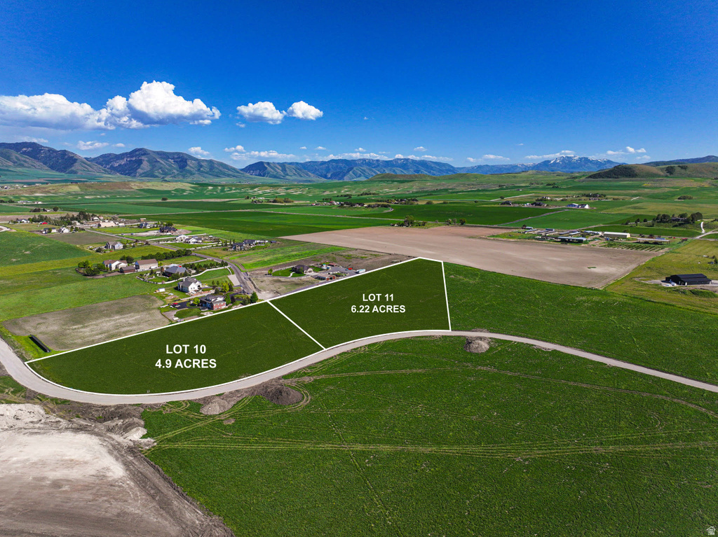 Aerial depiction of two expansive land lots, Lot 10 at 4.9 acres and Lot 11 at 6.22 acres, featuring green fields