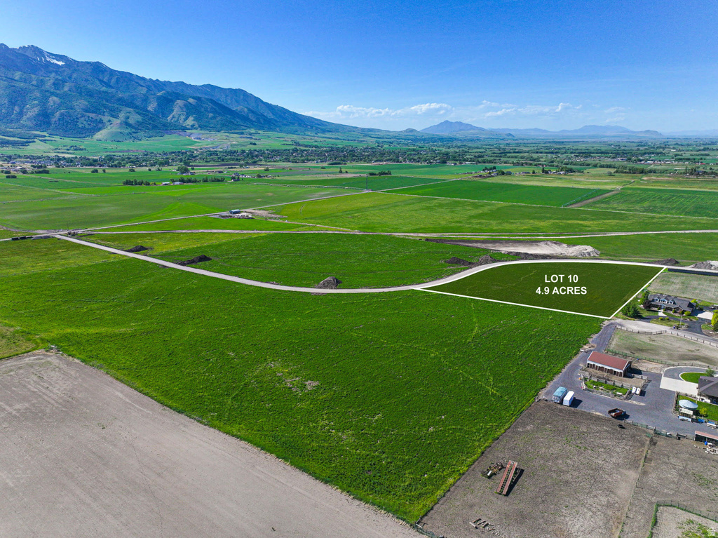 4.9-acre parcel featuring green fields and a mountain backdrop