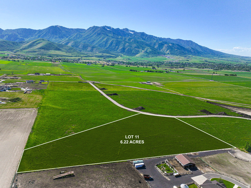 Expansive 6.22-acre lot featuring lush green fields and a mountain backdrop