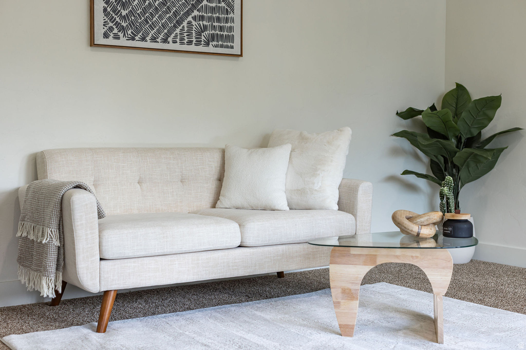 Neutral painted walls in a room featuring carpet flooring and a light-toned area rug