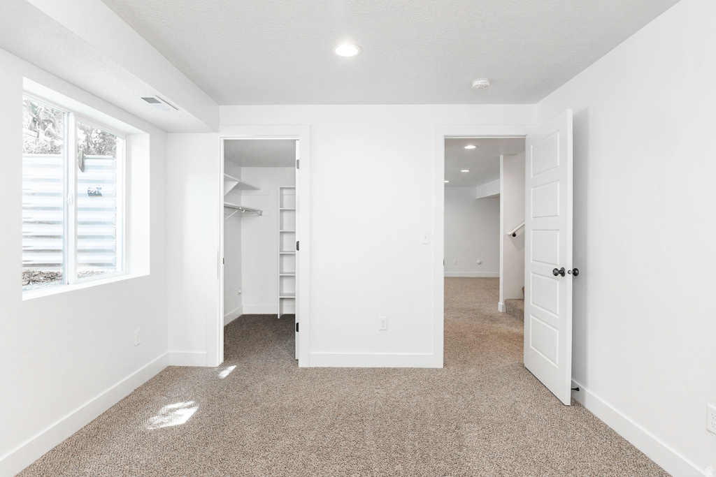 Bright room with plush carpet flooring and clean white walls