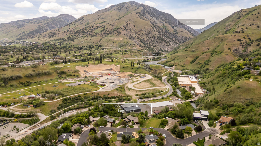 Aerial perspective showcasing the surrounding mountainous terrain and a winding river