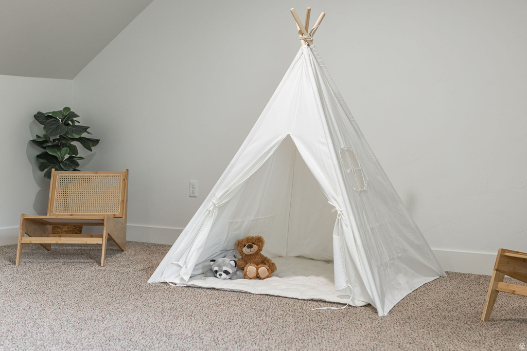 Carpeted room featuring a neutral color palette