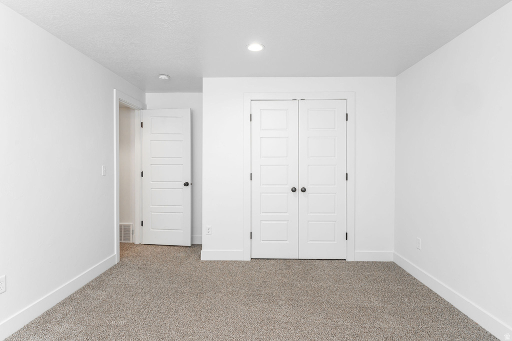 Neutral tone carpeting complemented by white walls