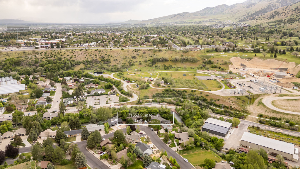 Aerial perspective showcasing a residential neighborhood with surrounding natural landscapes