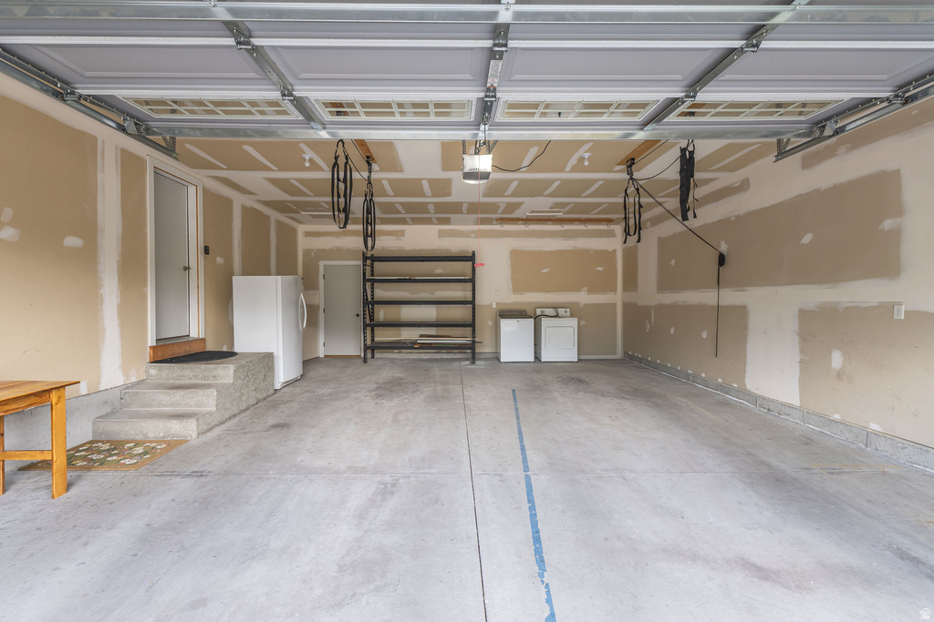 Spacious garage featuring a concrete floor, overhead lighting, and interior access