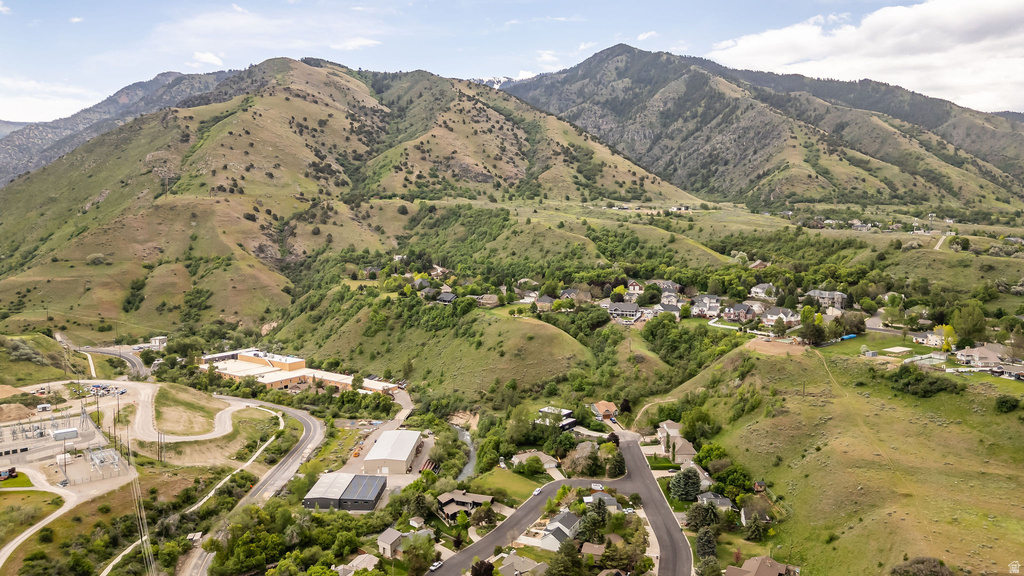 Mountainous terrain featuring green hillsides and scattered residential areas
