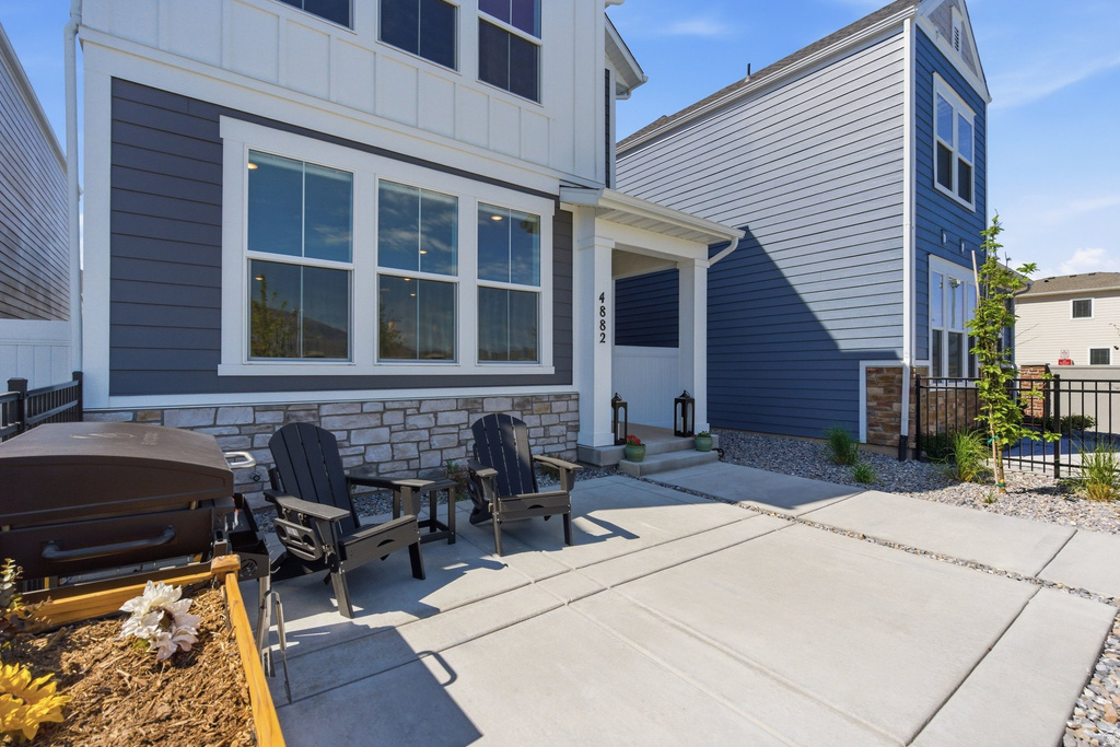 Contemporary exterior featuring horizontal siding and stone veneer accents