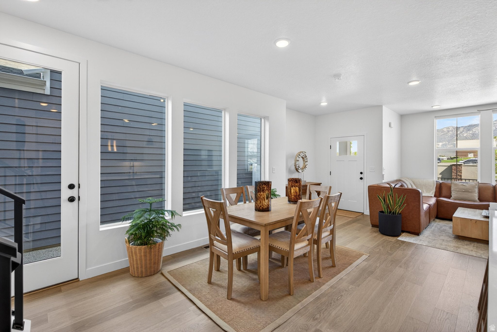 Open-concept living space featuring wood-finish flooring, recessed lighting, and white trim