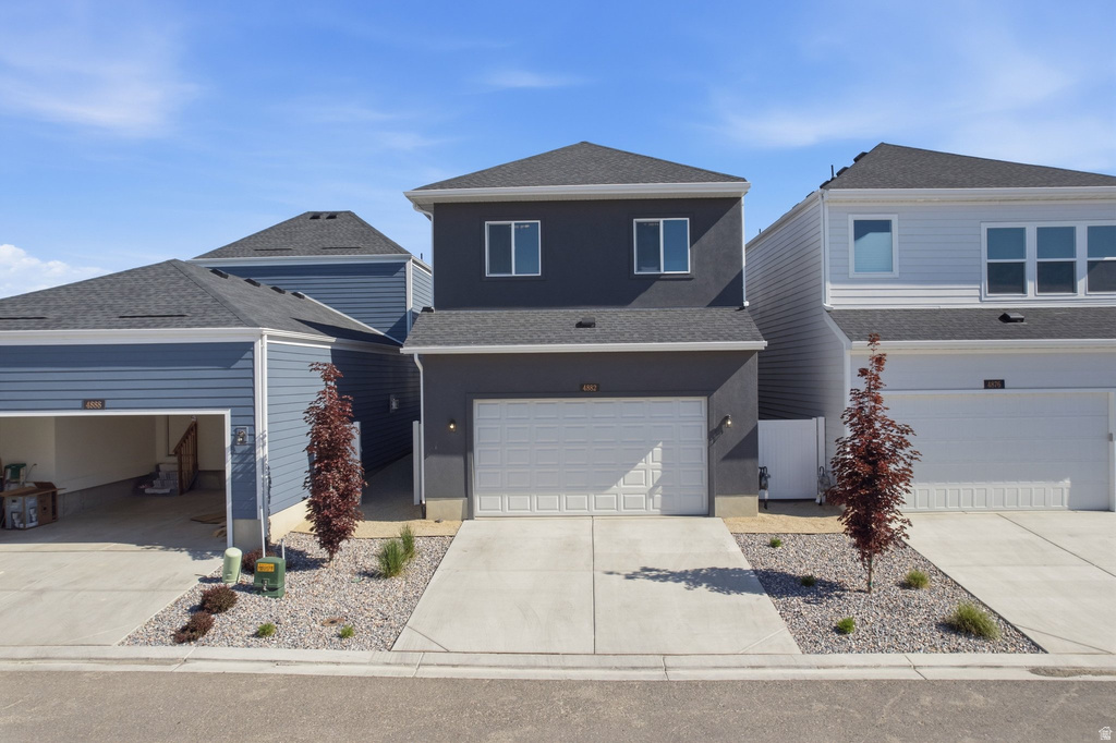 Contemporary two-story residence featuring a dark gray stucco facade