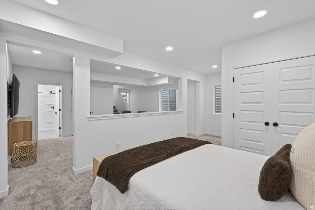 Bright interior space with recessed lighting, light-toned walls, and grey carpeting
