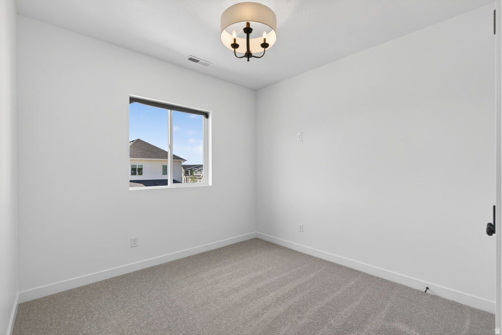 Neutral-toned carpet flooring complements the white walls and trim