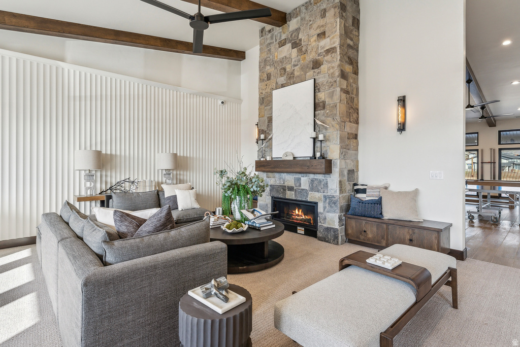 Spacious living area featuring a stone-clad fireplace with a natural wood mantel, a built-in bench, and a modern ceiling fan