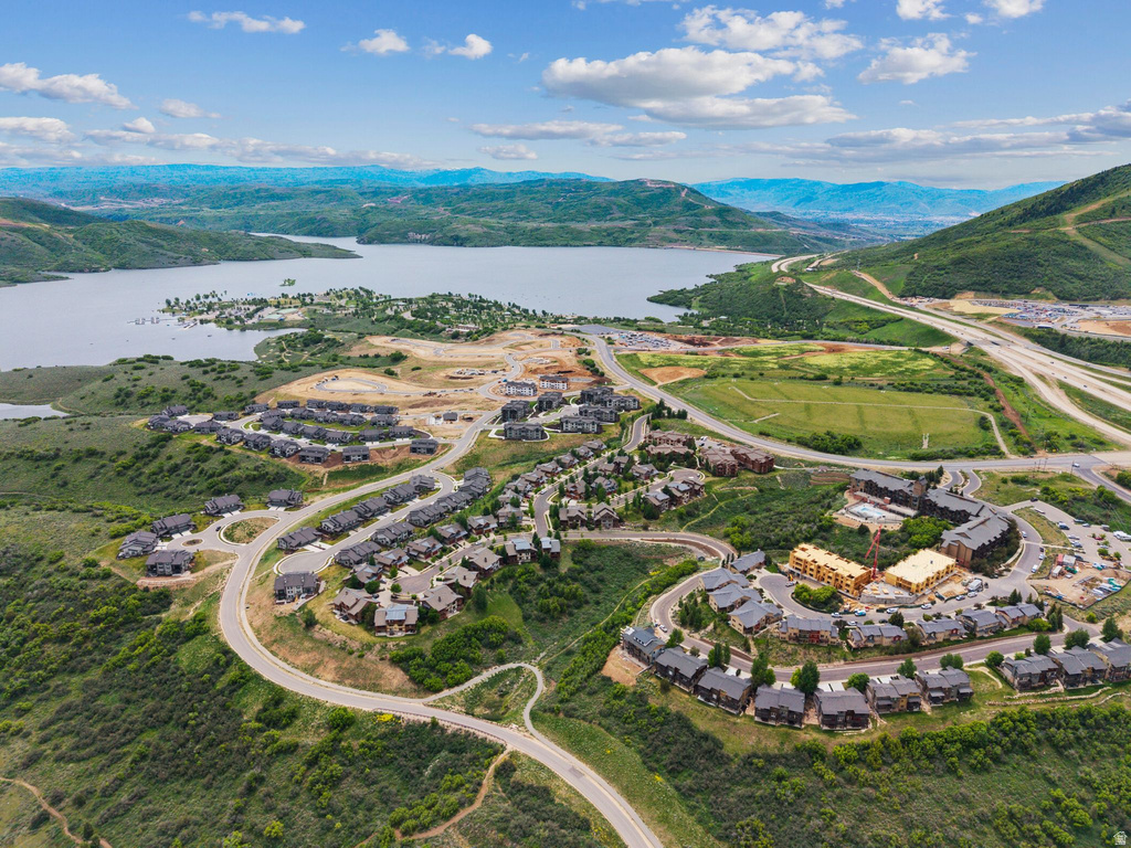 Aerial perspective showcasing a residential development with extensive green hillsides