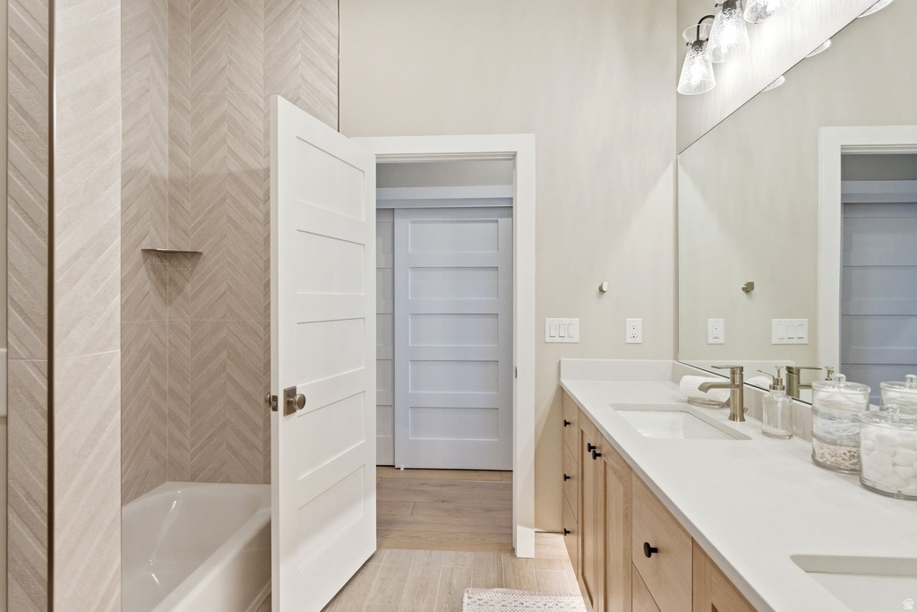 Bathroom featuring a dual vanity with light-toned cabinetry, white countertops, and undermount sinks