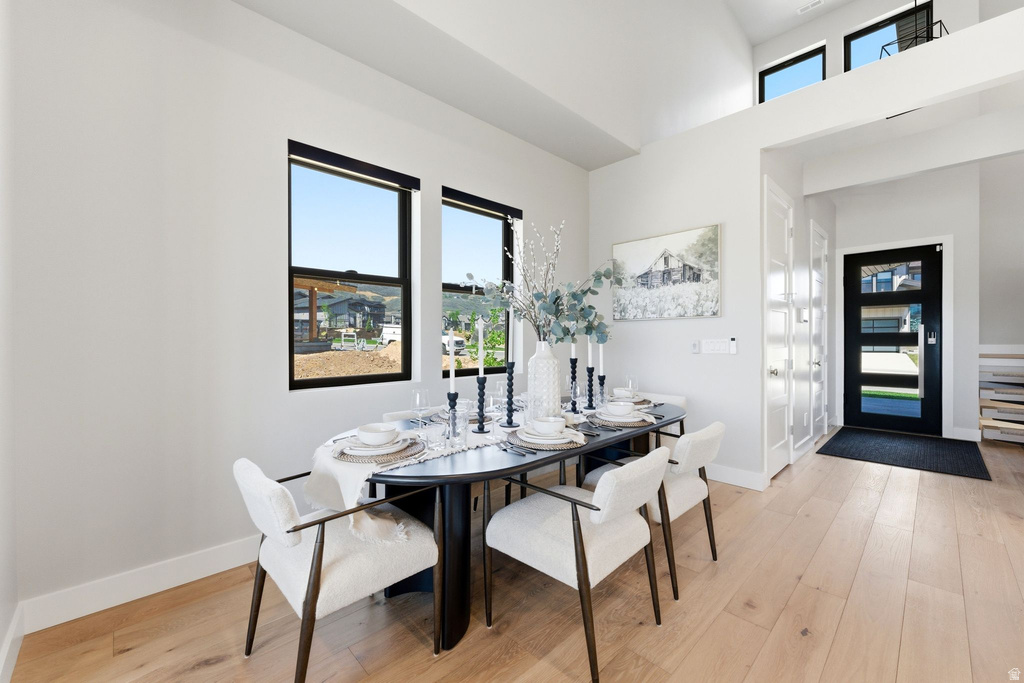 Light wood-finish flooring complements the white walls and high ceilings