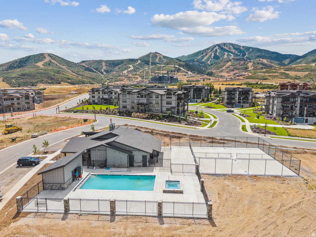 Community amenities featuring a swimming pool, integrated spa, and two enclosed courts