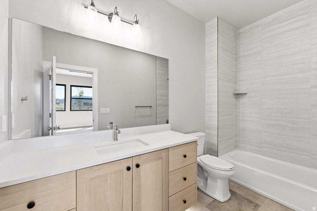 Contemporary bathroom with a light wood-finish vanity, white countertop, and integrated sink