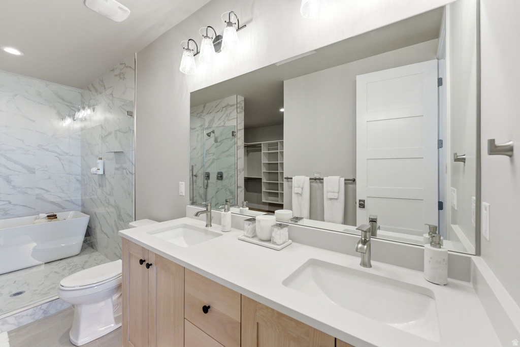 Dual vanity with light wood-finish cabinetry, white countertops, and undermount sinks