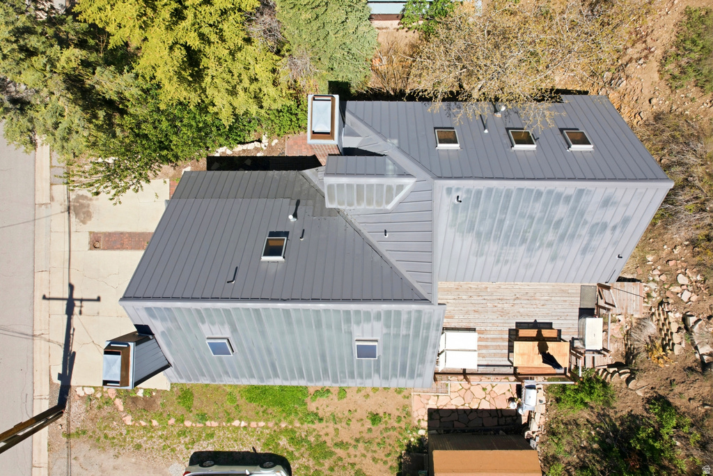 Modern construction featuring a multi-level metal roof with multiple skylights