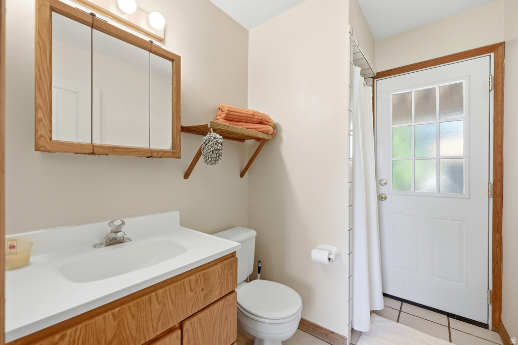 Bathroom featuring a wood-finish vanity with an integrated sink and chrome faucet