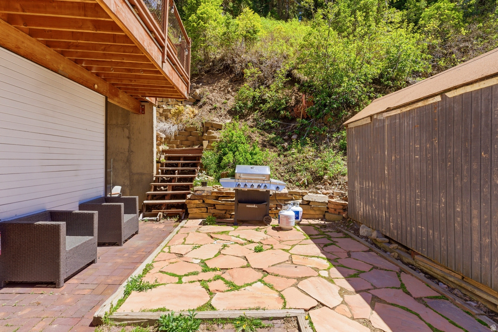 Outdoor patio with flagstone flooring, brick pavers, and natural stone retaining walls