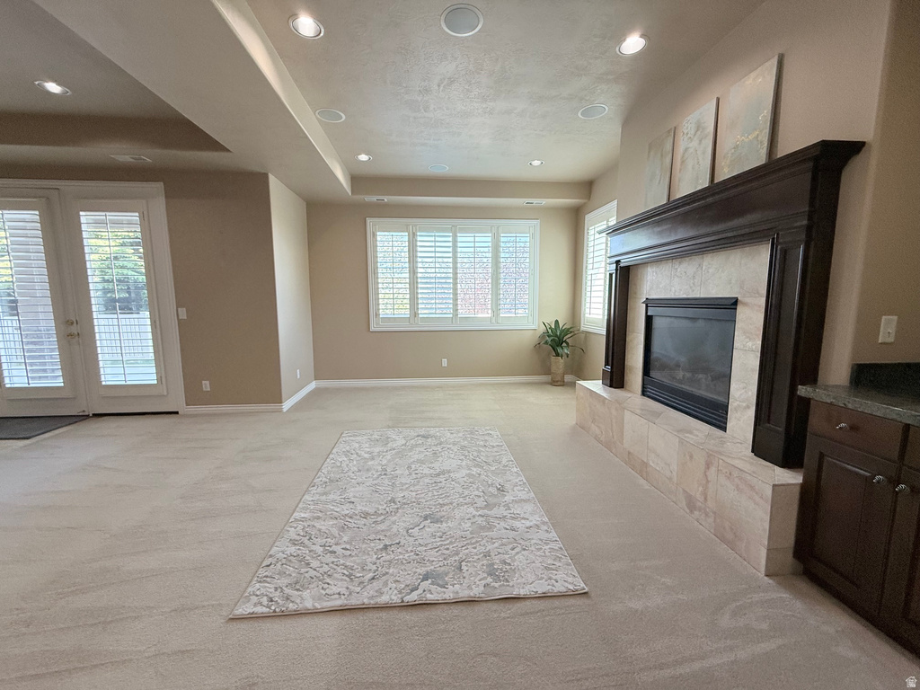 Spacious living area featuring a built-in fireplace with a dark wood mantle and a tile surround