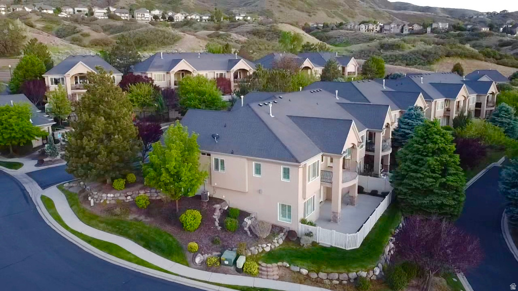Expansive property featuring a multi-level structure with a stucco exterior, a dark shingle roof, and multiple balconies