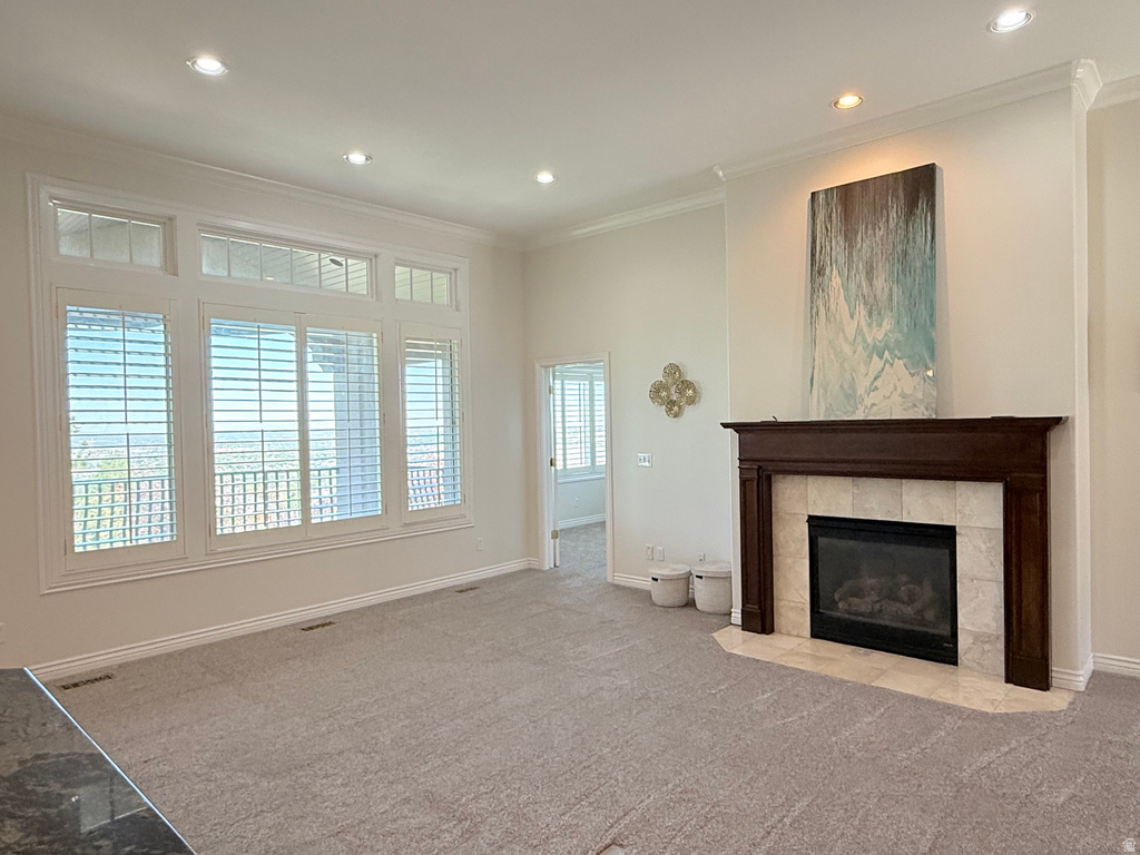 Spacious living area featuring a central fireplace with a dark wood mantel and light-toned tile surround
