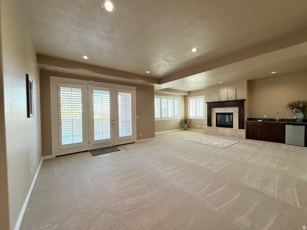 Spacious room featuring light-toned carpeting and recessed lighting