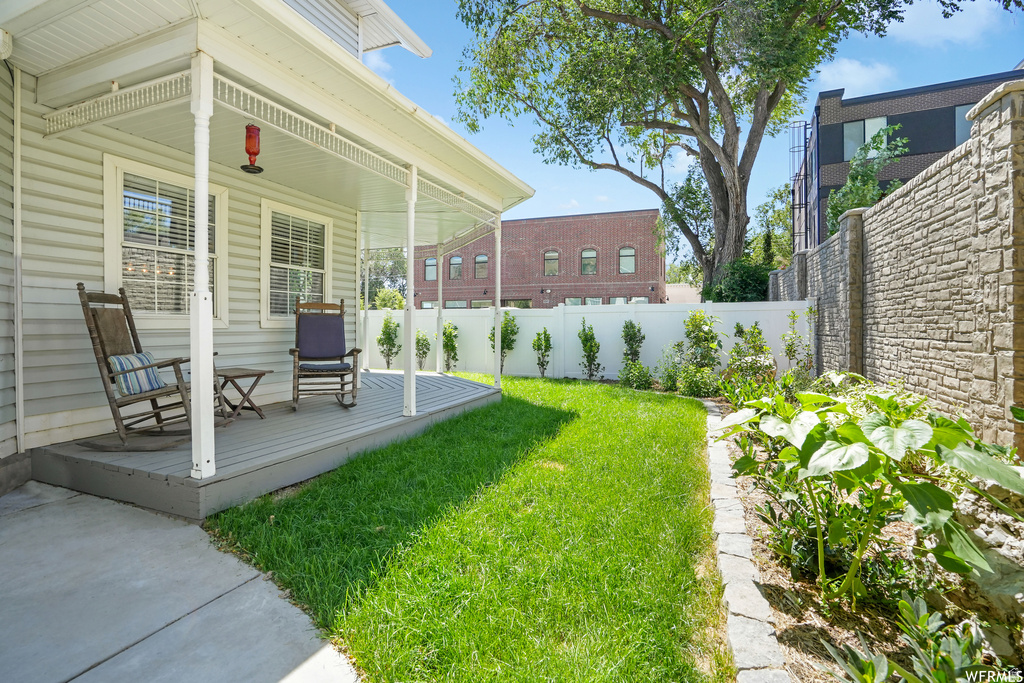 Covered front porch with white columns, horizontal siding, and multiple windows