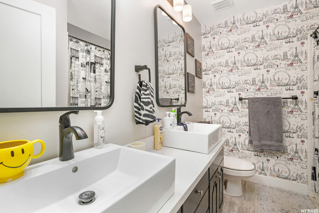 Double vanity with rectangular vessel sinks, matte black faucets, and quartz-finish countertops