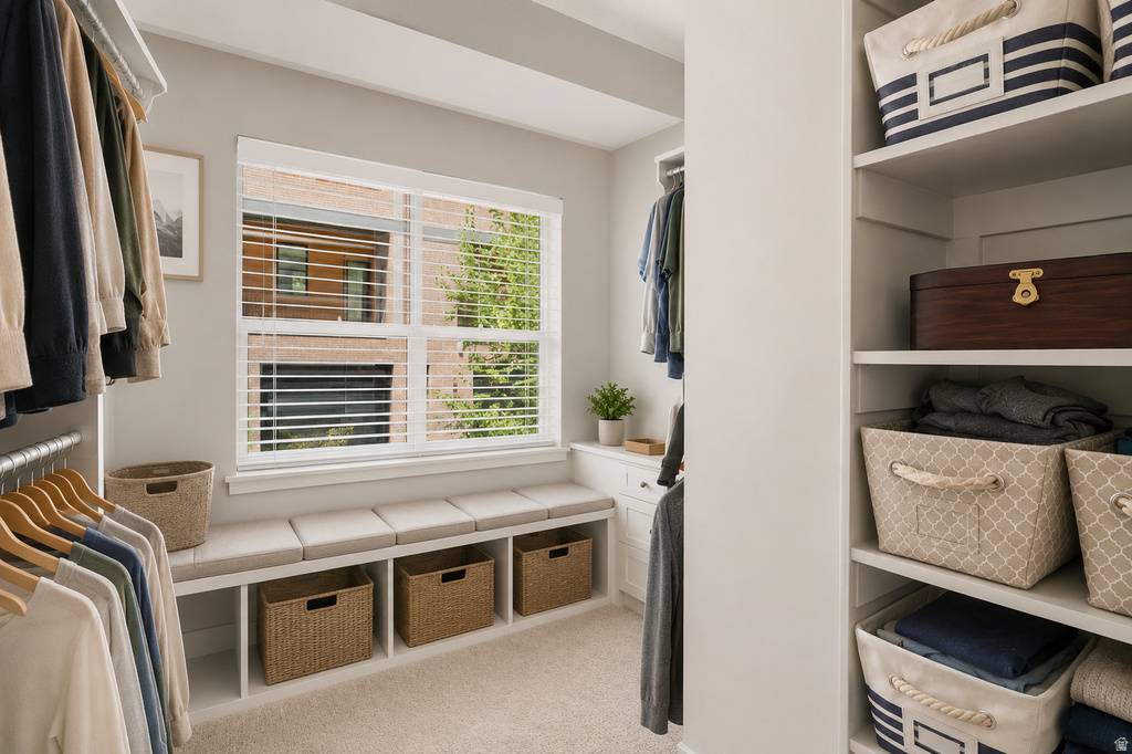 Custom closet system featuring built-in shelving, hanging rods, and a window seat with integrated storage cubbies