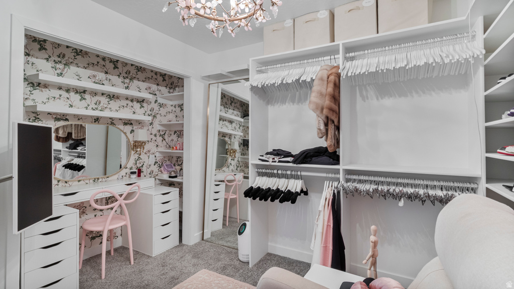 Custom closet featuring built-in shelving, ample hanging storage, and a dedicated vanity area with a mirror