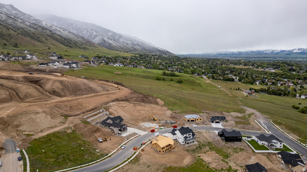 Developing residential area featuring a mix of completed homes, homes under construction, and graded lots