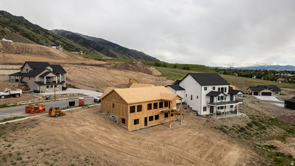 New construction framing featuring multiple window openings, a hip roofline, and an elevated deck support structure