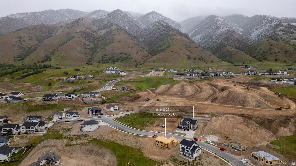 Developing residential community with paved roads and mountain backdrop