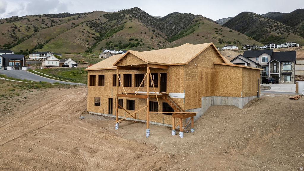 New construction home featuring a two-story design with a tiered deck structure