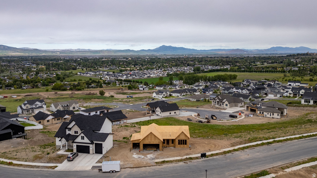 Expansive new construction development featuring diverse architectural styles and a mountain backdrop