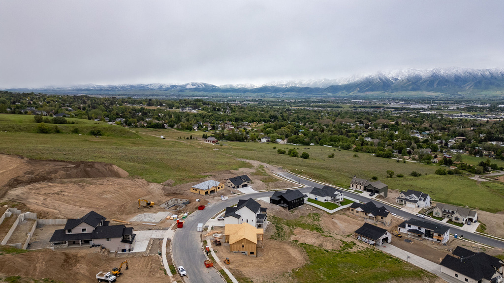 Developing residential area featuring a mix of completed homes, homes under construction, and undeveloped lots