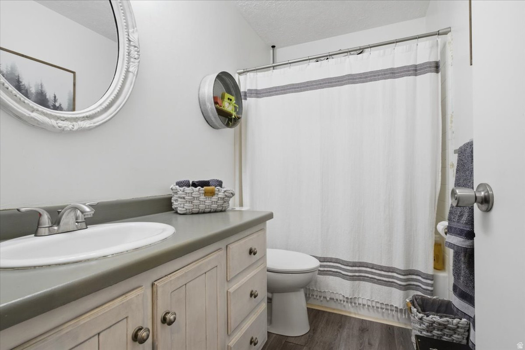 Bathroom featuring a vanity with a drop-in sink, gray countertop, and distressed cabinet base with bronze hardware