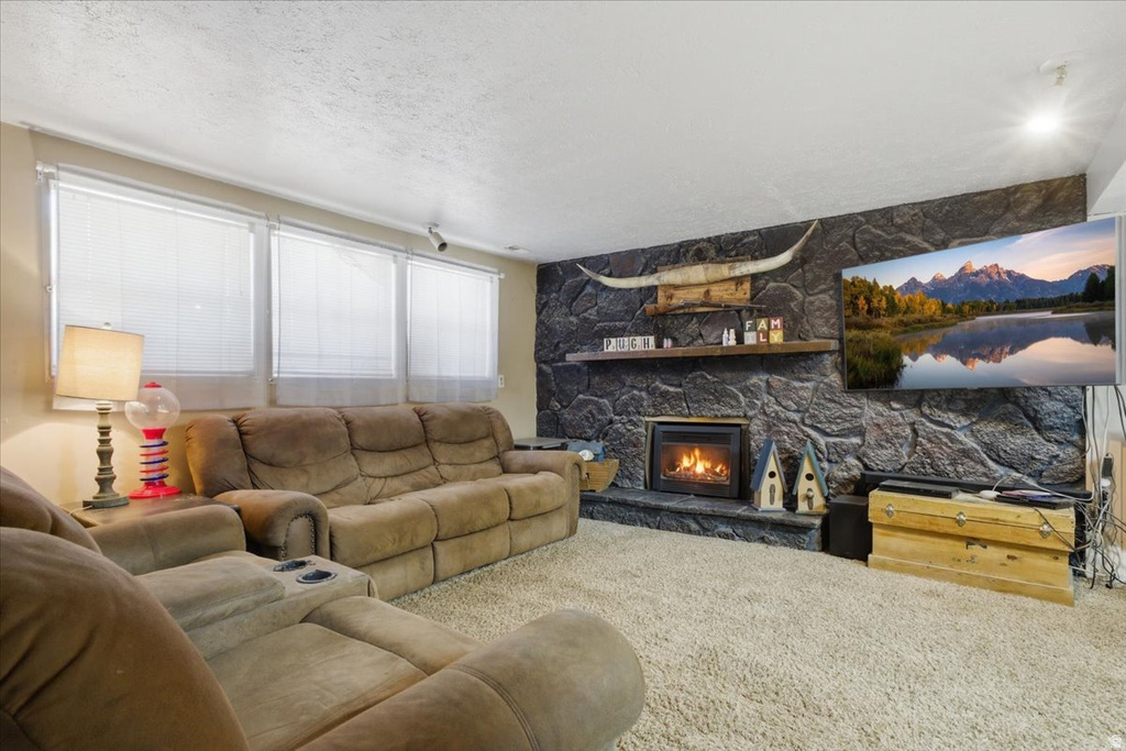 Living area featuring a stone accent wall with a built-in fireplace