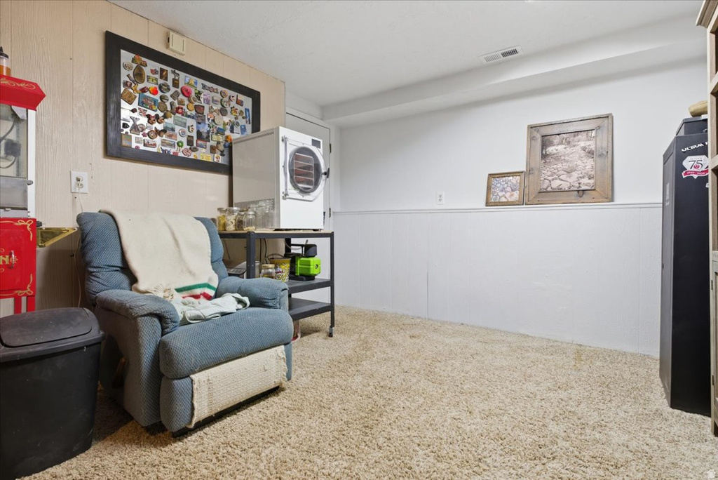 Carpeted room with white wainscoting and paneled walls