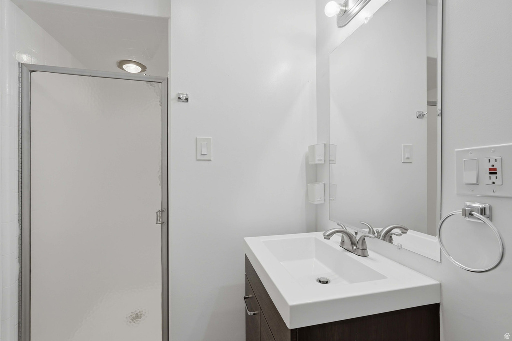 Modern vanity with integrated sink, brushed nickel faucet, and frameless mirror