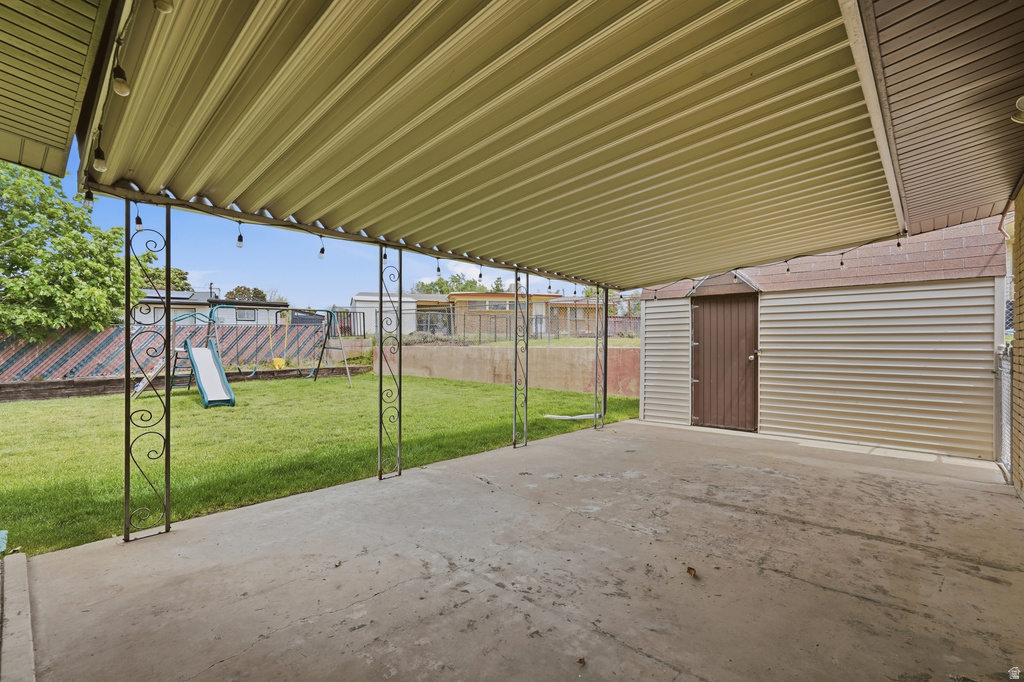 Covered patio featuring a concrete slab and decorative metal supports