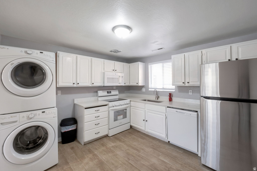 Kitchen area featuring white cabinetry, light-toned countertops, and wood-finish flooring