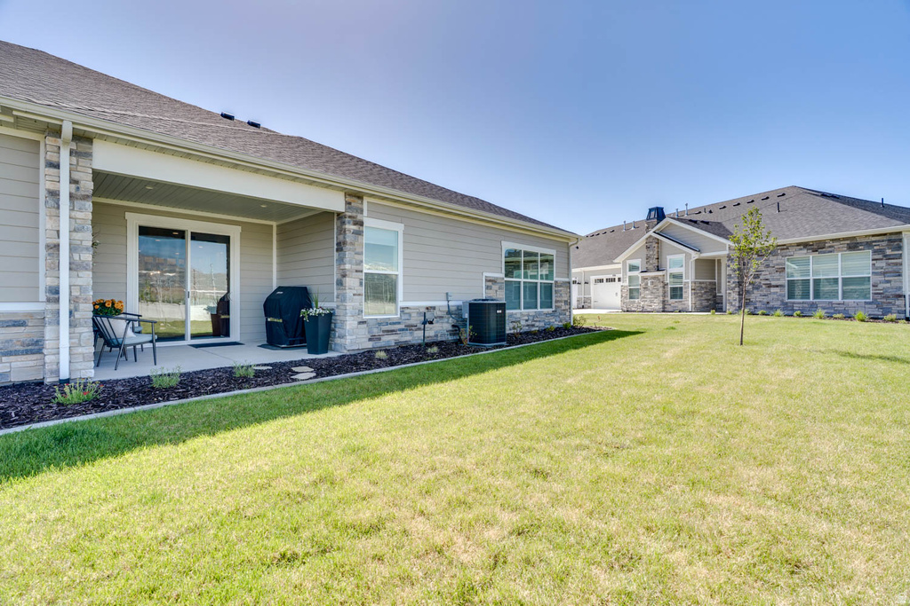 Rear exterior featuring a covered concrete patio with sliding glass door access