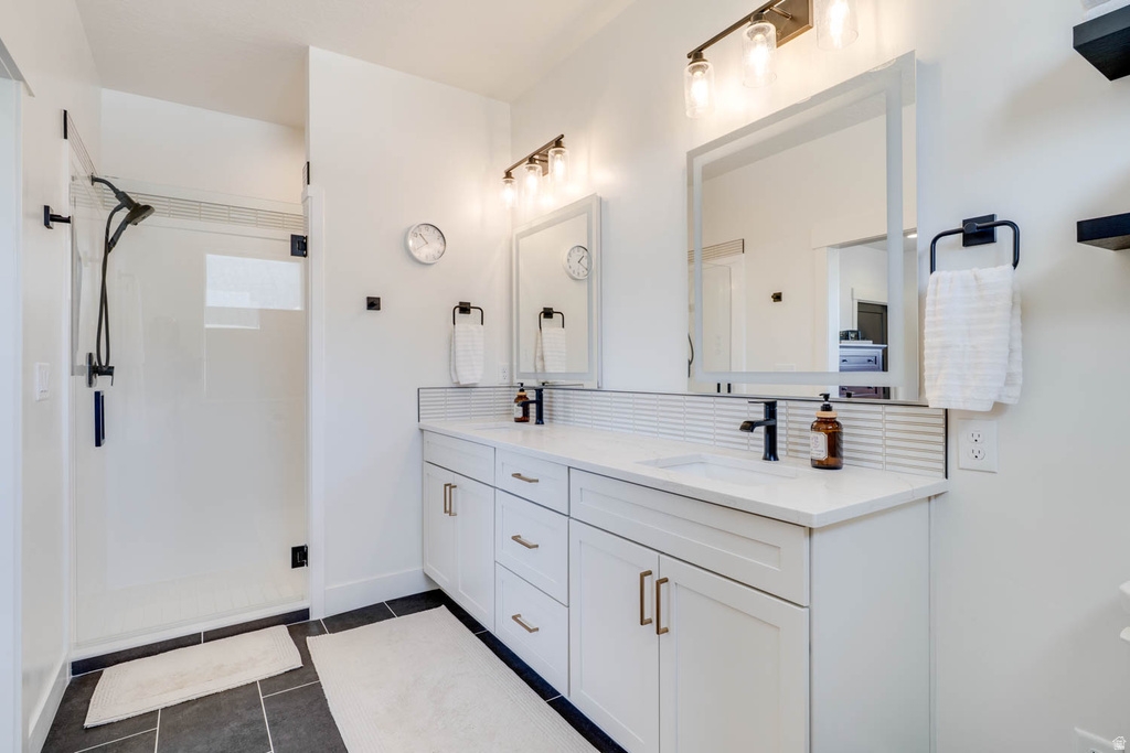 Double vanity with undermount sinks and white countertops, featuring matte black faucets and light fixtures