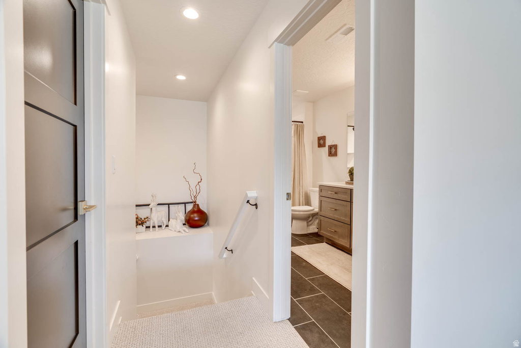 Hallway with recessed lighting and light-toned flooring
