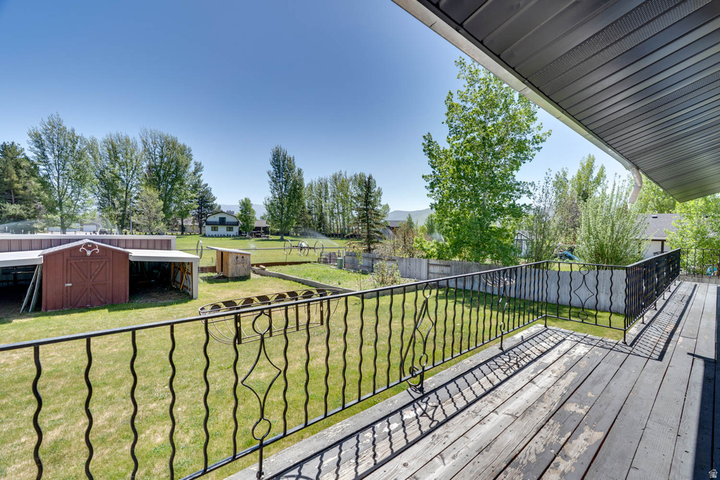 Exterior deck with wood-finish flooring and decorative wrought iron railing